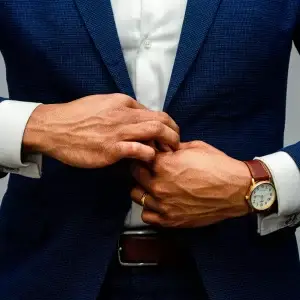 Man buttoning his suit jacket
