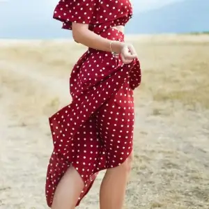 Women in red dress on beach