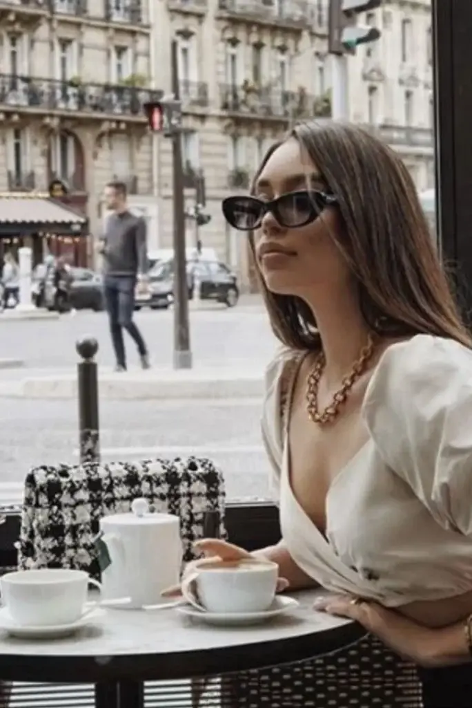 Young Woman sat at cafe table in Europe